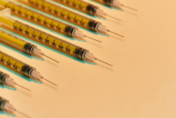 Close up of medical syringes for injections lying isolated over light background. Injection medicine concept - Photo, Image