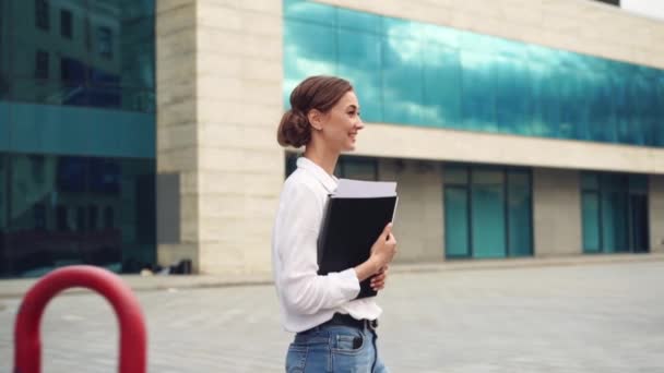 Businesswoman successful woman business person standing outdoor corporate building exterior. Pensiv caucasian confidence professional business woman middle age  - Materiaali, video