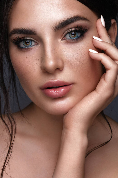 Beautiful girl with bright fashionable make-up, freckles and blue eyes. Beauty face. - Fotografie, Obrázek