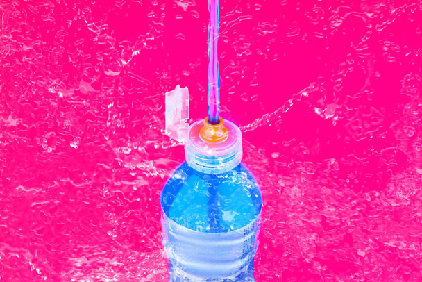 Sports drink bottle squirting and splashing liquid - Photo, Image