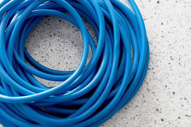 Blue rubber water hose that has already been curled up - Photo, Image