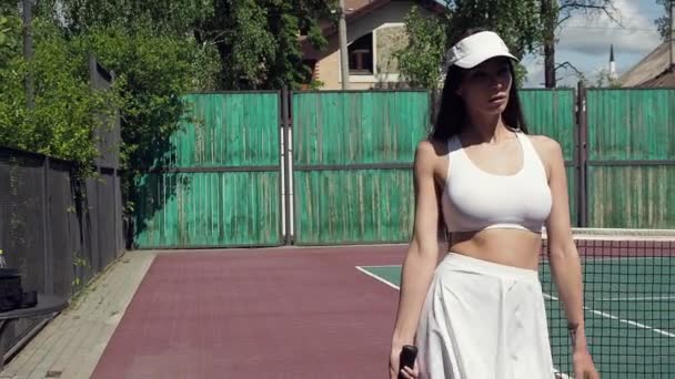Crop woman playing tennis on court - Materiaali, video