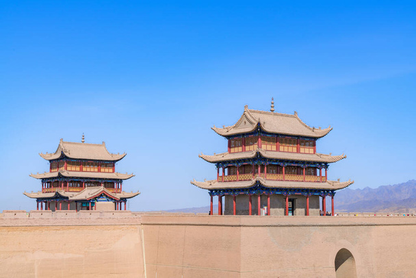 The majestic Jiayuguan City watchtower in Gansu Province, China. Chinese characters on black plaque: Place names of Jiayuguan.The majestic Jiayuguan Great Wall Corner Tower in Gansu Province, China.The turret of the Great Wall in Jiayuguan - Photo, Image