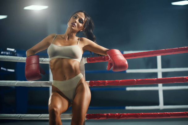 Female fighter in underwear posing near ring. - Фото, изображение