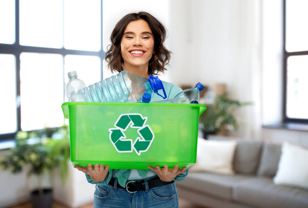 smiling young woman sorting plastic waste - Photo, Image