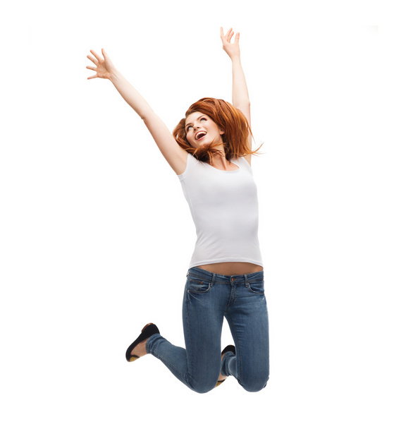 Teenage girl in white blank t-shirt jumping - Foto, imagen
