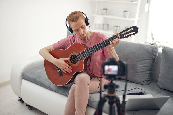 Guitarist making video lessons and tutorials for internet vlog website classes. - Фото, изображение