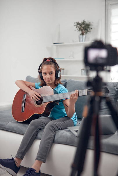 Chitarrista bambino che fa video lezioni e tutorial per le classi del sito internet vlog. - Foto, immagini