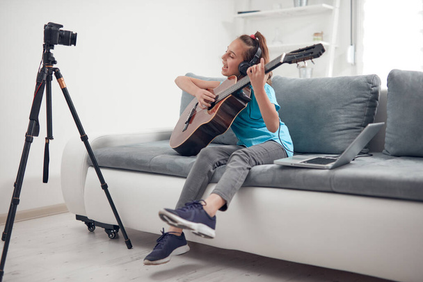 Дитячий гітарист робить відео уроки та навчальні посібники для веб-сайтів у відеоблозі
. - Фото, зображення