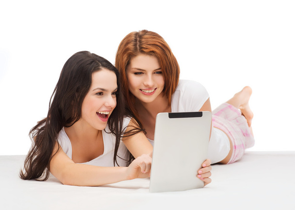 Two smiling teenage girls with tablet pc computer - Valokuva, kuva