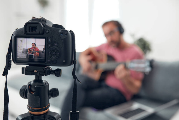 Guitarist making video lessons and tutorials for internet vlog website classes. - Fotó, kép