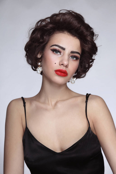 Vintage style portrait of young beautiful woman with glamorous makeup - Photo, image