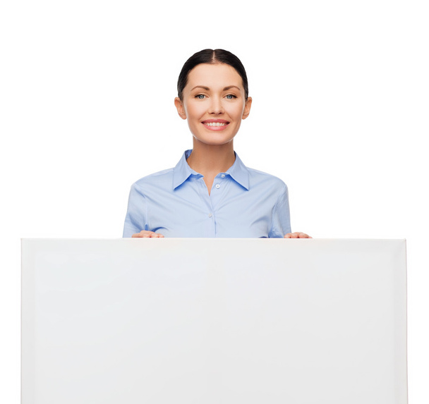 Smiling businesswoman with white blank board - Fotoğraf, Görsel