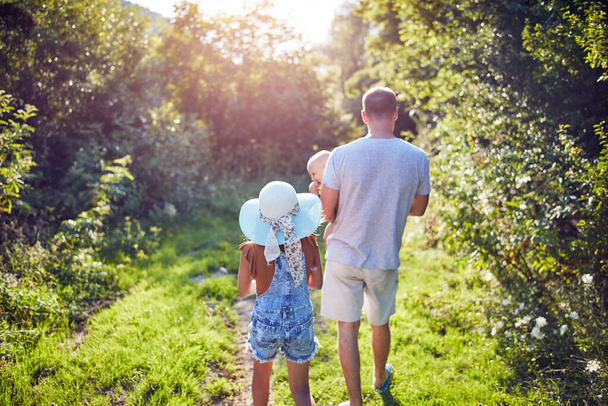 Father and child enjoying walking in a countryside nature. - Photo, Image