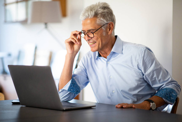 Close up portrait businessman with glasses looking at laptop computer - Foto, imagen