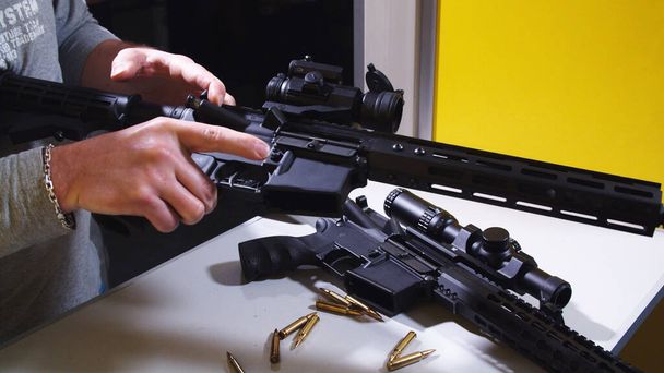 Shooting instructor loading an assault rifle at a shooting range. - Photo, Image