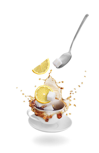 Tea with lemon on a white background. Tea in a cup. - Photo, Image