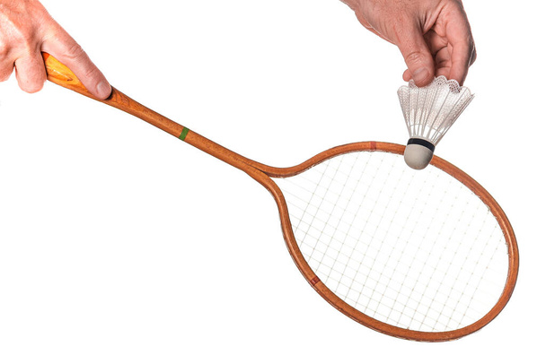 Vintage wooden badminton racket in hand isolated on white background - Photo, Image