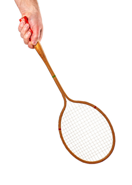 Vintage wooden badminton racket in hand isolated on white background - Фото, изображение