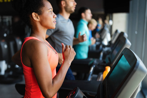Group of people running on treadmill in gym doing cardio workout - Φωτογραφία, εικόνα