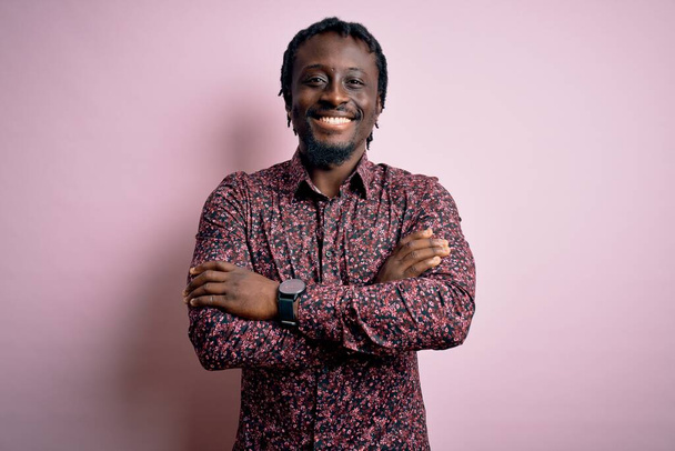 Young handsome african american man wearing casual shirt standing over pink background happy face smiling with crossed arms looking at the camera. Positive person. - Foto, Bild