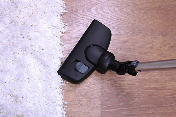 Vacuuming carpet in house - Фото, изображение