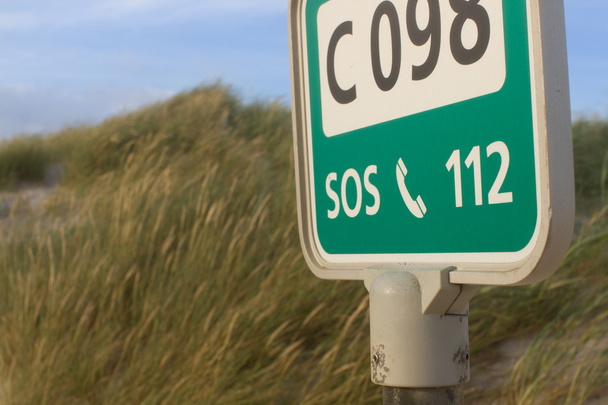 112 sign and grass-covered sand dunes - Photo, Image