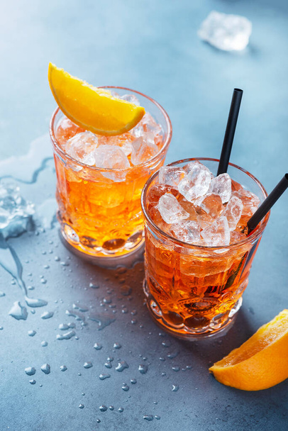 Two glasses of a traitional Italian cocktail aperrol spritz with orange and ice. Selective focus imge with a copy space for your text. - Fotoğraf, Görsel
