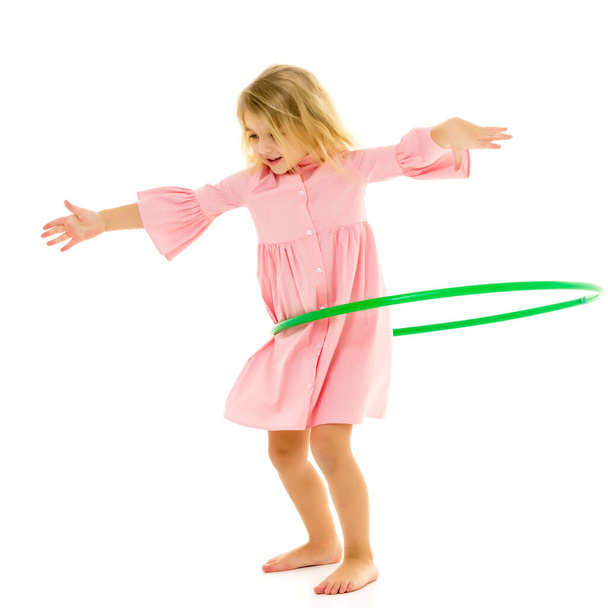 Beautiful Barefoot Girl in Pink Dress Standing with Hula Hoop - 写真・画像