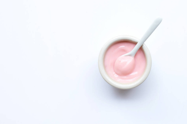 Ceramic bowl of  pink strawberry yogurt on white background. - Fotoğraf, Görsel