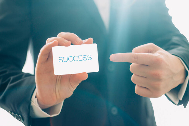 Close up view of businessman holding visit card and pointing. Business success concept - Photo, Image
