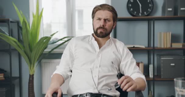 Serious man listening business colleagues during video call - Felvétel, videó