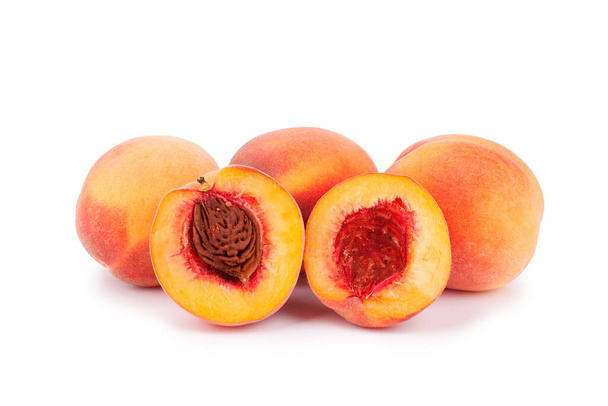 Velvet peaches whole and halves with stone on a white background isolated close up - Photo, Image