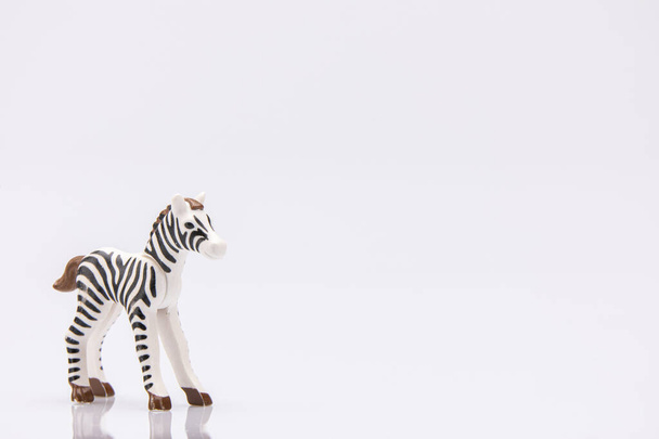 close up of a plastic stripped zebra isolated on a white background - Foto, afbeelding