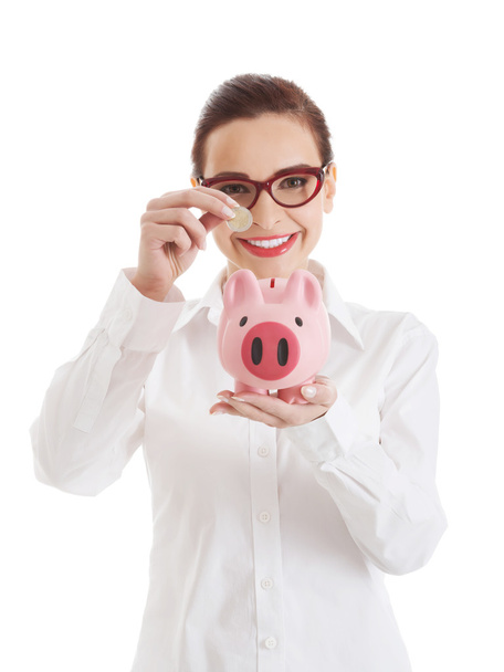 Beautiful business woman with coin and piggy- bank. - Foto, Bild