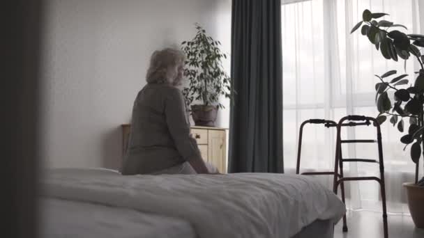 Abandoned senior female crying in nursing home room, suffering helplessness - Video, Çekim