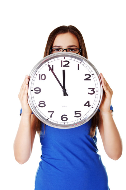 Young casual woman holding clock. - Photo, Image