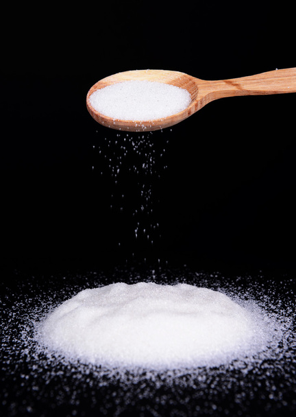 Sugar isolated on black - Foto, imagen