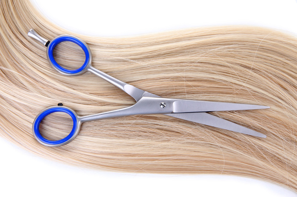 Long blond hair and scissors isolated on white - Foto, imagen