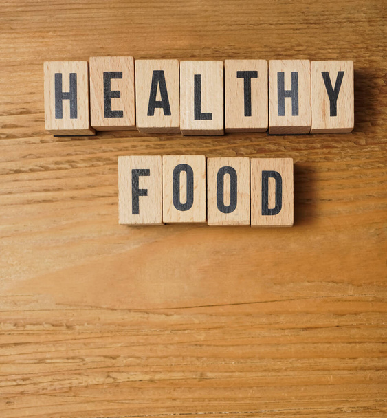 healthy Food the words on wooden blocks. Healthy or unhealthy food nutrition concept. empty copy space for inscription. - Foto, Imagen