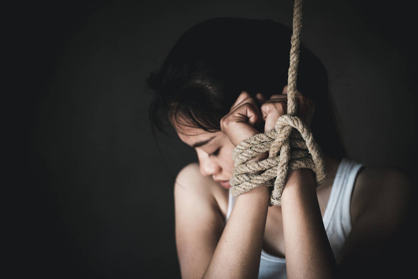 Hands of a missing kidnapped, abused, hostage, victim woman tied up with rope in emotional stress and pain, Human trafficking ,Stop abusing violence. - Foto, Bild