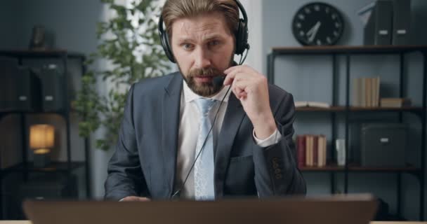 Man in headset having video call with business partners - Materiaali, video