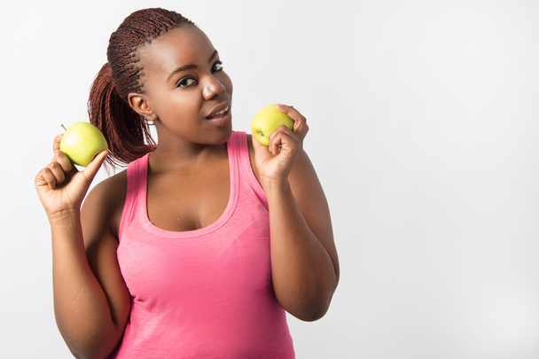 Pretty Black Mujer sosteniendo dos manzanas verdes
 - Foto, Imagen