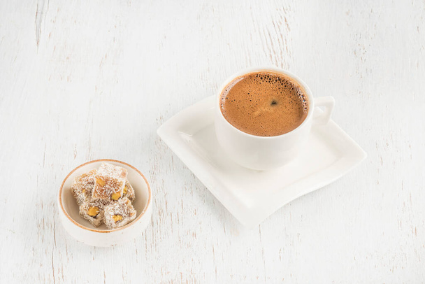 a cup of coffee and turkish delights on wooden table with copy space - Photo, Image