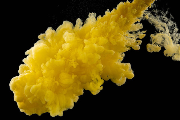 Yellow ink in water. Ink reacting in water. Creative. Black background - Foto, immagini