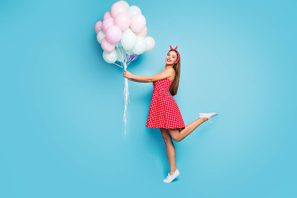 Full length body size profile side view of nice feminine dreamy cheerful cheery straight-haired girl holding air balls having fun jumping isolated on bright vivid shine vibrant blue color background - 写真・画像