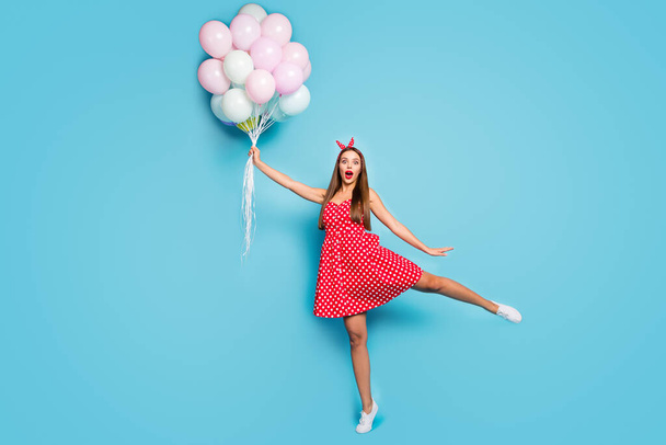 Full length body size view of nice attractive lovable girlish funny funky comic cheerful straight-haired girl holding air balls having fun isolated on bright vivid shine vibrant blue color background - Фото, зображення