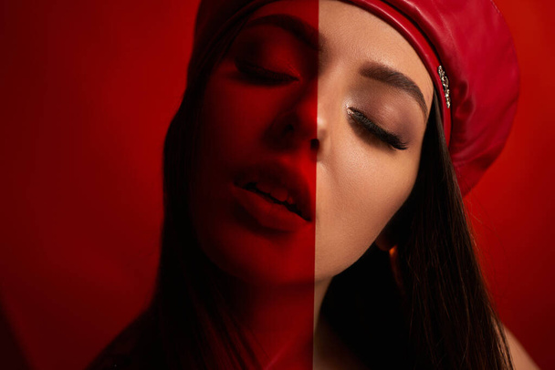 woman in red leather beret - Фото, изображение