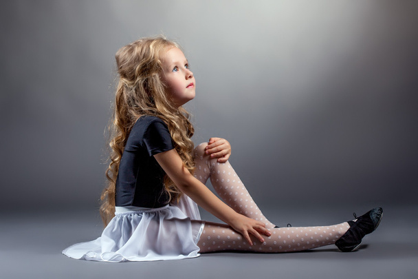 Image of curly blonde dancer sitting in studio - Photo, Image