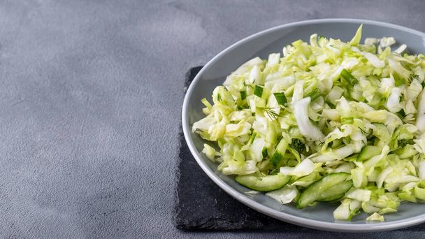 Cabbage salad with cucumber and fennel. Healthy and diet food concept. Text space - Photo, Image